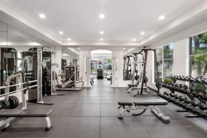 a gym with several treadmills and weights at Stunning & Spacious Apartments at Miramar Lakes in South Florida in Miramar