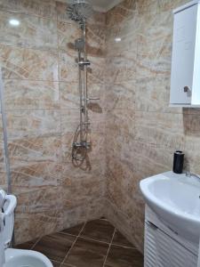 uma casa de banho com um chuveiro, um WC e um lavatório. em Вила Вайлин em Batak