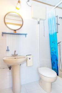 a bathroom with a sink and a toilet and a mirror at Beach Guesthouse Mediteran in Podstrana +51 photos