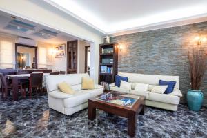 a living room with two white couches and a table at Oceanviewvilla in Karpathos