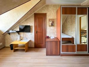 a room with a desk with a computer and a staircase at Asian Mountains in Bishkek
