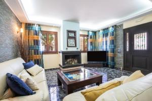 a living room with a couch and a fireplace at Oceanviewvilla in Karpathos