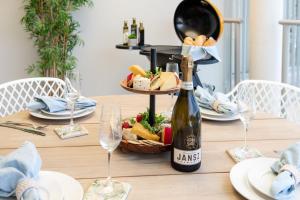 una mesa con una botella de vino y una cesta de comida en Pacific Blue - Premiere, en Airlie Beach