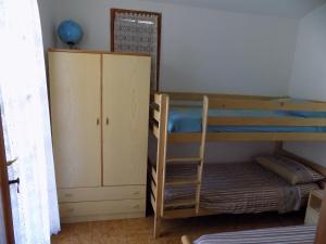 a bedroom with two bunk beds and a cabinet at Casa Vacanze Gardenia in Solanas