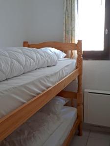 a pair of bunk beds in a room with a window at Charming Apt With Balcony In La Plagne Montalbert in La Plagne