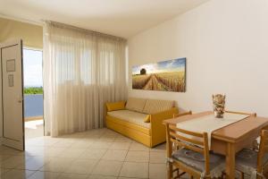 a living room with a couch and a table at Residence Hotel Piccadilly in Rimini