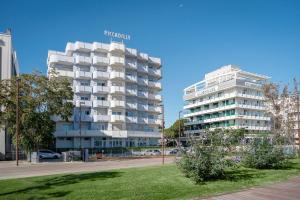 a white building with a sign on the side of it at Residence Hotel Piccadilly in Rimini