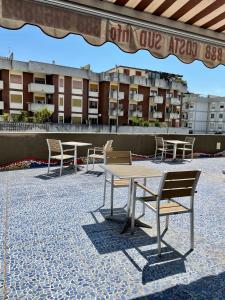 a table and chairs on a patio with a building at Costa Sud Salerno in Salerno