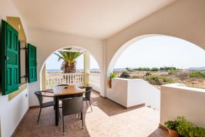 balcón con mesa, sillas y vistas al océano en Oceanviewvilla, en Karpathos