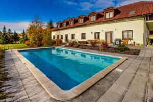 a swimming pool in front of a house at Benešovka in Vacov