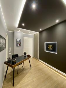 a living room with a table and a black wall at Morelli B&B in Rossano Stazione