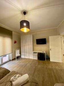 an empty living room with a couch and a television at Morelli B&B in Rossano Stazione