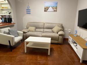 a living room with a couch and a table at Casa Tortuga 1era linea de playa in Alcalá