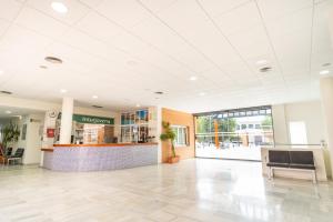 a large lobby with a waiting area in a building at Albergue Inturjoven Sevilla in Seville