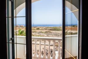 a room with a view of the ocean from a balcony at Oceanviewvilla in Karpathos
