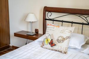 a bed with a pillow and a lamp on a table at Oceanviewvilla in Karpathos