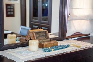a table with a mirror and some candles on it at Oceanviewvilla in Karpathos
