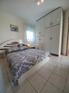 a bedroom with a large bed and a white cabinet at Gaby's Villa in Koinyra