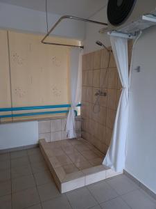 a bathroom with a shower with a shower curtain at Gaby's Villa in Koinyra +26 photos