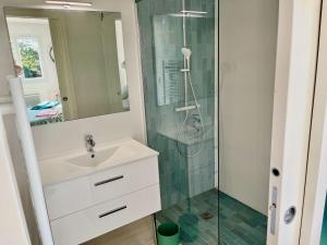 a bathroom with a sink and a shower at Villa Caprier in Le Pradet