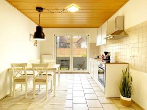 a kitchen with a table and chairs in a room at Cosy & Central-Apartments in Gelsenkirchen in Gelsenkirchen