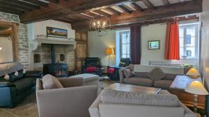 a living room filled with furniture and a fireplace at Le Moulin de la Motte - 12 personnes in Bellenot-sous-Pouilly