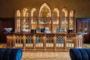 a bar in a room with a lot of alcohol at Matfen Hall Hotel, Golf & Spa in Matfen