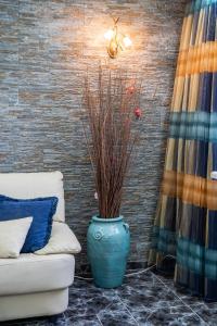 a blue vase sitting next to a couch in a room at Oceanviewvilla in Karpathos