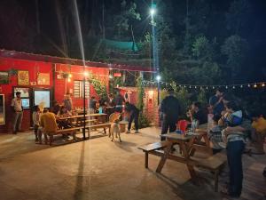 a group of people and a dog on a stage at Kumaon Roadies Adventure Camp & Resort in Mukteshwar