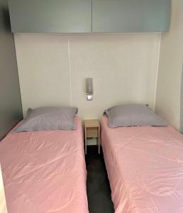 two beds sitting next to each other in a room at Roccapina in Lumio