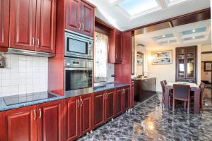a kitchen with red cabinets and a table with chairs at Oceanviewvilla in Karpathos