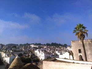 a city with a palm tree and a castle at DonVito Casa Vacanze in Alberobello