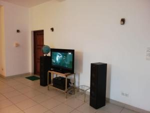 a living room with a flat screen tv and speakers at Haus Berlin in Negombo