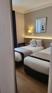 Ein Bett oder Betten in einem Zimmer der Unterkunft Magda Champs Elysées
