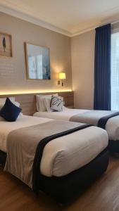 Ein Bett oder Betten in einem Zimmer der Unterkunft Magda Champs Elysées