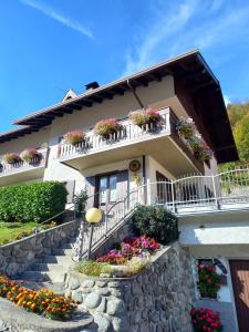 a building with flower boxes on the balconies and stairs at B&B Piazzi di Katia in Caderzone Terme