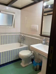 W łazience znajduje się toaleta, wanna i umywalka. w obiekcie San Giovanni Lovely Loft w Rzymie