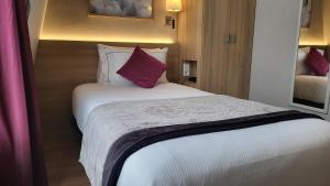 Ein Bett oder Betten in einem Zimmer der Unterkunft Magda Champs Elysées