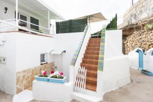 a staircase in a white house with colorful tiles at Casa Laura y Pancho in Fasnia