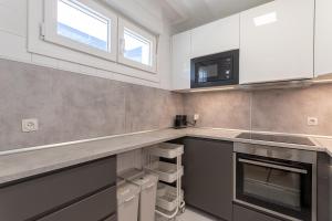 a kitchen with white cabinets and a counter top at Bakio Seaview V by Aston Rentals in Bakio