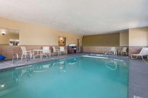 a pool in a hotel room with chairs and tables at Best Western Richfield Inn in Richfield