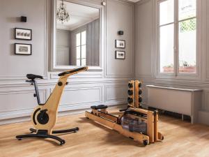 a gym with a exercise bike in a room at New Hotel Roblin in Paris