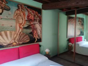 a bedroom with a painting on the wall and a bed at Casa Giampy in Bergamo