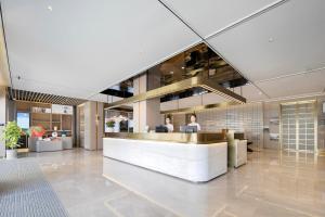 a lobby with a reception desk in a building at Atour Hotel Jiashan Dazhong Plaza in Jiashan