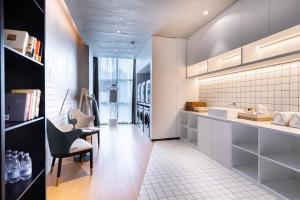 a kitchen with a sink and a dishwasher at Atour Hotel Anqing Municipal Affairs Center Seventh Street in Anqing