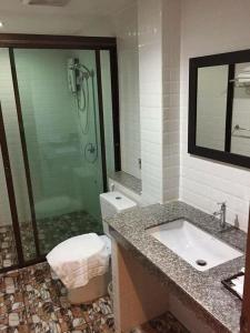 a bathroom with a shower and a sink and a toilet at Chan Chiangmai House in Chiang Mai