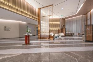 a lobby of a building with a lobby at Atour Hotel Wuxi New District Nanchan Temple Scenic Area in Wuxi