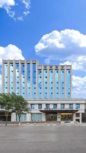 un gran edificio blanco con muchas ventanas en Atour Hotel Luliang Central Park en Luliang