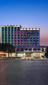 a large building with a lot of windows at Atour Hotel Luliang Central Park in Luliang