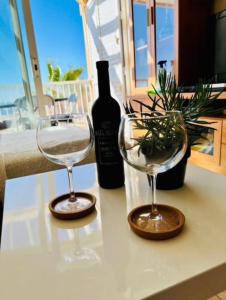 two wine glasses and a bottle of wine on a table at Bella Vista in Poris de Abona